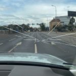 Crack On The Windshield Of The Car, A Trace Of A Stone On The Ro