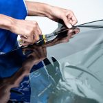 Car Side Window Film Removal And Tinting Installation. Male Auto
