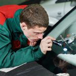 professional windscreen repair services - repairman repairing windscreen
