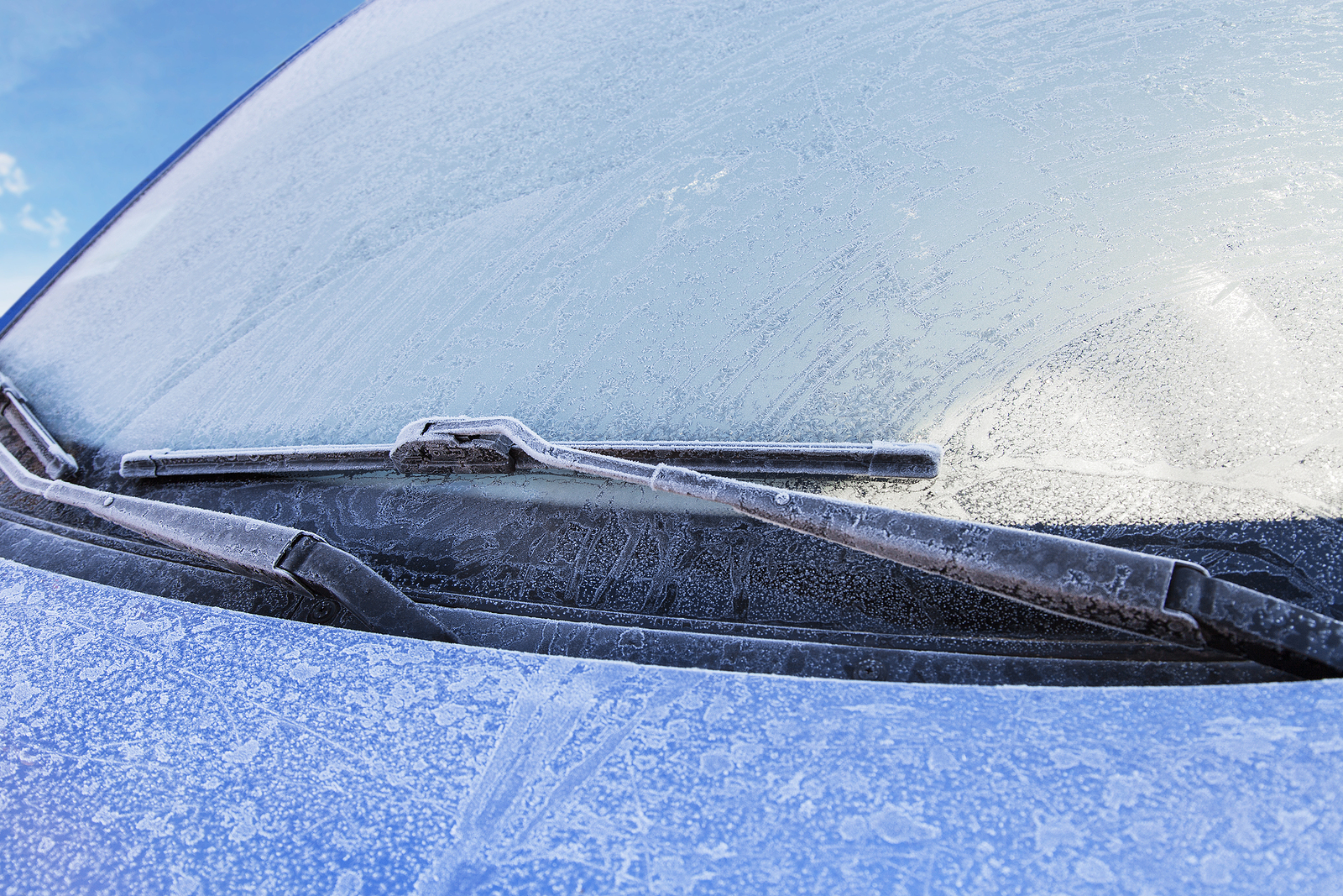 Frozen front windshield of car during winter morning